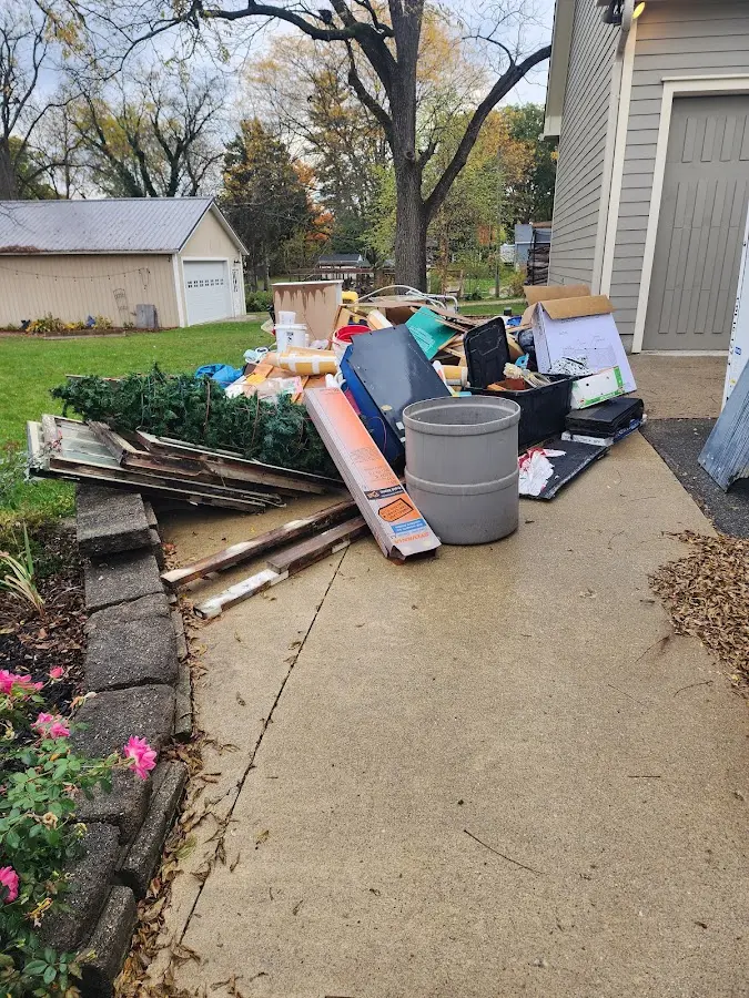 Dumpster being loaded with debris for 12 Yard Dumpster Rental in Bardmoor